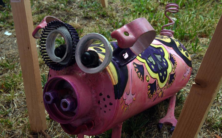 A pig made out of pieces of scrap metal on display at U.S. Army Garrison Bavaria's booth at a traditional market in Grafenwoehr, Germany, Sunday, July 28, 2019. 
