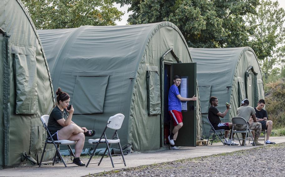 Soldiers relax in a tent city after work on a military base in Powidz, Poland, Aug. 27, 2019. The tent city and an old dorm house almost 1,100 U.S. military personnel on the installation. 

