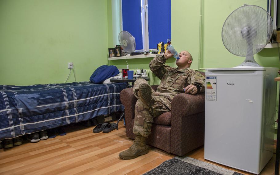 Capt. Dustin Martin, the base mayor, sits in his dorm room on a military base in Powidz, Poland, Aug. 27, 2019. He shares the room with two other soldiers. 

