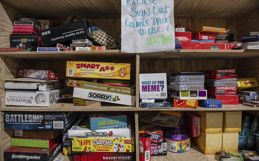Games fill a bookshelf at the Morale, Welfare and Recreation tent on a military base in Powidz, Poland, Aug. 27, 2019.

