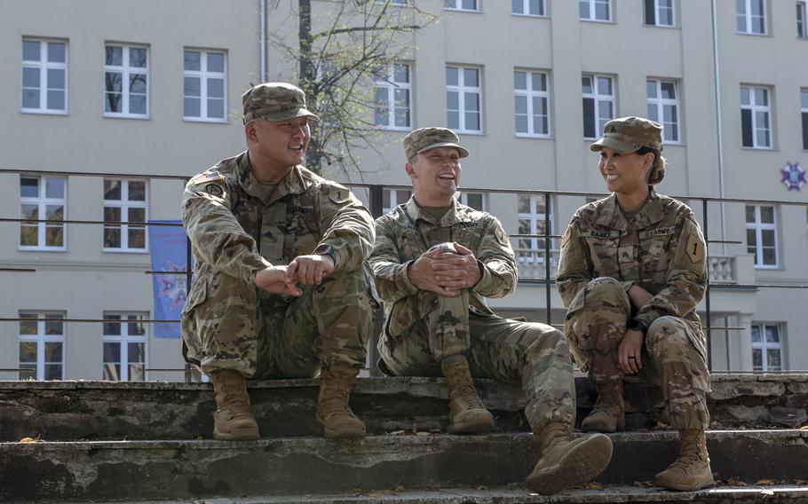 From left, Sgt. Jason Cho, Spc. Joseph Salas and Sgt. Jennie Banks from the 1st Infantry Division sit in front of a newly constructed building on a Polish military base in Poznan, Aug. 28, 2019.

