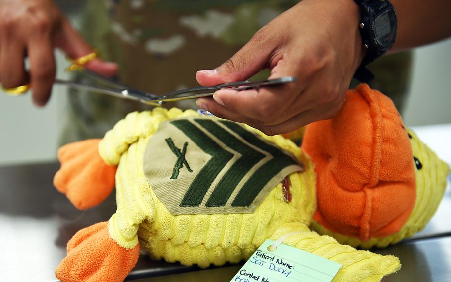 A stuffed duck, named "Sgt. Ducky," is operated on at the suture clinic for stuffed animals at Vilseck, Germany, Wednesday, Aug. 28, 2019. 