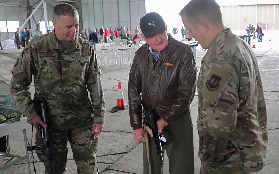 Local Bill King, center,  explains World War II weapons to Sr. Master Sgt. Casey Schmid, left, and Maj. Ken French on Friday, Sept. 6, 2019, during the 75th Anniversary Heritage Day on RAF Fairford, England.