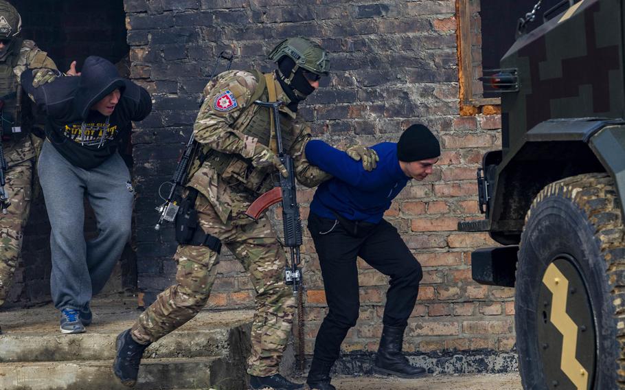 Ukrainian soldiers detain simulated enemy forces during a fire team movement and room-clearing demonstration as part of Rapid Trident 2019, Sept. 20, 2019, near Yavoriv, Ukraine. 

