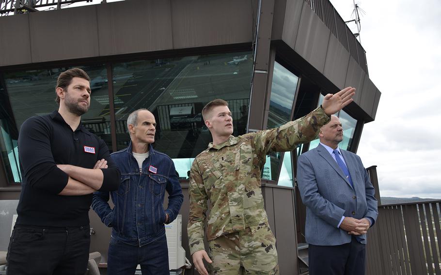 Actors John Krasinski, left, and Michael Kelly, along with Scott Lockard, 86th Airlift Wing vice director, and 1st Lt. Joshua Bartness, 86th Civil Engineer Squadron construction management chief, look out over the flight line during a base tour on Ramstein Air Base, Germany, Oct. 15, 2019. 