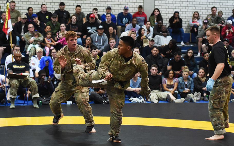 Mathew Alfaso, right, attempts a spinning back kick on Patrick Keane, during the 2nd Cavalry Regiment Fight Night, Friday, Oct. 18, 2019, at Vilseck, Germany.