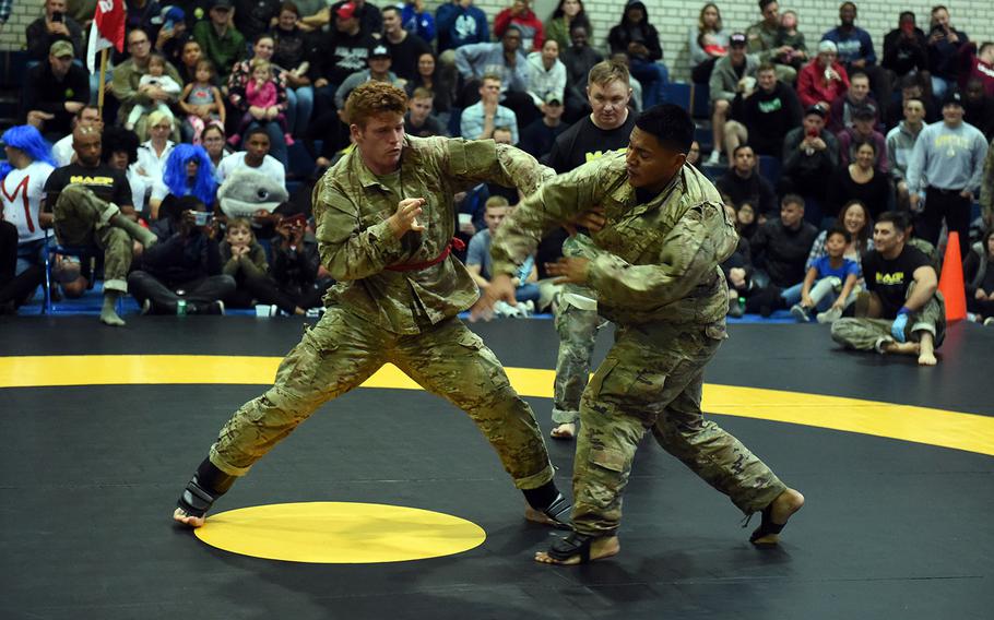 Sgt. Mathew Alfaso, right, attempts a spinning back kick on Sgt. Patrick Keane, during the 2nd Cavalry Regiment Fight Night, Friday, Oct. 18, 2019, in Vilseck, Germany. 