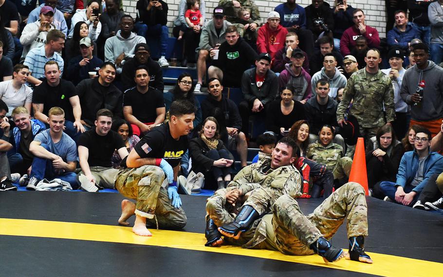 Sgt. 1st Class Logan Malie locks in an armbar on Sgt. Trayquan Pearson during the 2nd Cavalry Regiment Fight Night, Friday, Oct. 18, 2019, in Vilseck, Germany.