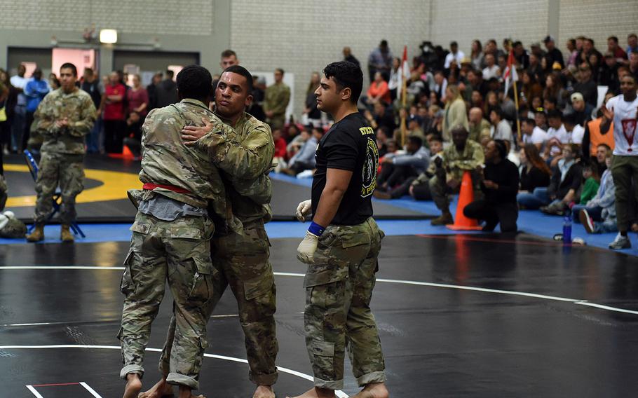 Staff Sgt. Raycel Dasher and Sgt. Cameron Twiggs embrace after a hard fight during the 2nd Cavalry Regiment Fight Night, Friday, Oct. 18, 2019, in Vilseck, Germany.