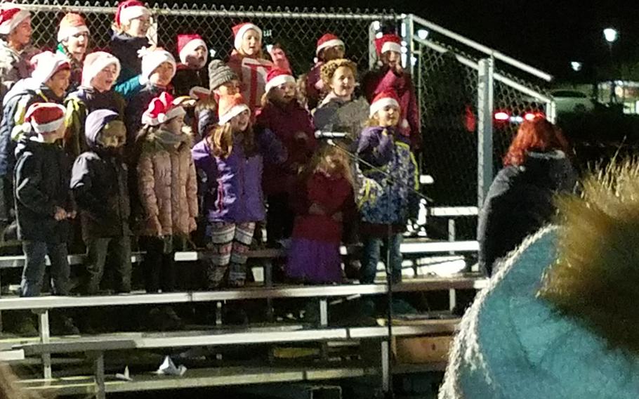 Children sing Christmas songs during the holiday tree lighting ceremony at Grafenwoehr, Germany, Tuesday, Dec. 3, 2019. 