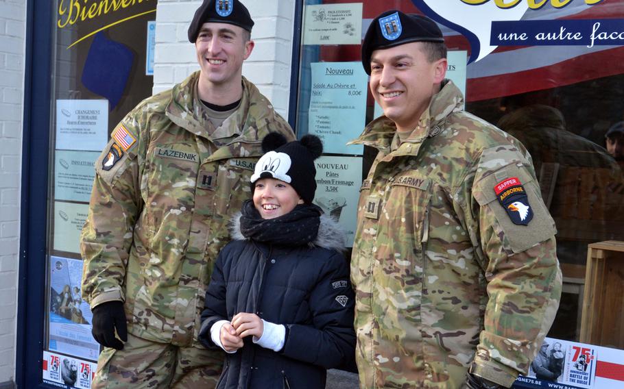 Capt. Jake Lazebnik, left, and Capt. Blake Ritchey of the 101st Airborne Division pose with a young Belgian on the streets of Bastogne, Belgium, Saturday, Dec. 14, 2019. The Screaming Eagles and other service members were in town to mark the 75th anniversary of the World War II Battle of the Bulge.









