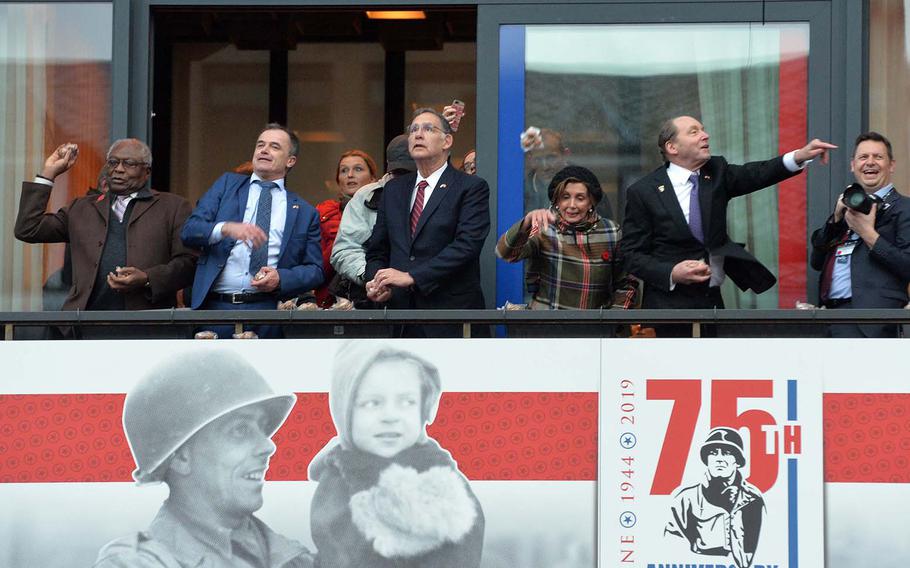 The American delegation along with the mayor of Bastogne, Belgium, for the traditional throwing of the nuts from the city hall balcony, Saturday, Dec. 14, 2019.