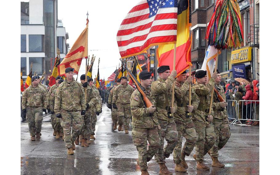 An American color guard followed by service members of the U.S. Army Garrison Benelux march through Bastogne, Belgium, Saturday, Dec. 14, 2019. The eastern Belgian town was marking the 75th anniversary of the Battle of the Bulge.