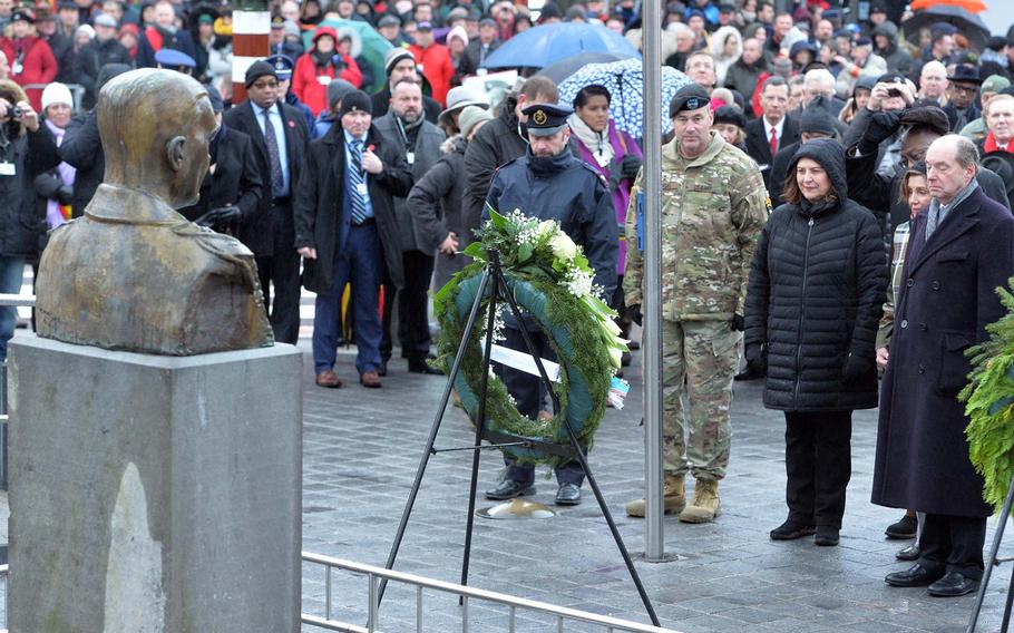 The American delegation that included Speaker of the House Nancy Pelosi, second from right, and 101st Airborne Division commander Maj. Gen. Brian Winski, second from left, lay a wreath at the monument to Gen. Anthony McAuliffe at the square named after him in Bastogne, Belgium. The ceremony was part of the celebrations marking the 75th anniversary of the Battle of the Bulge.