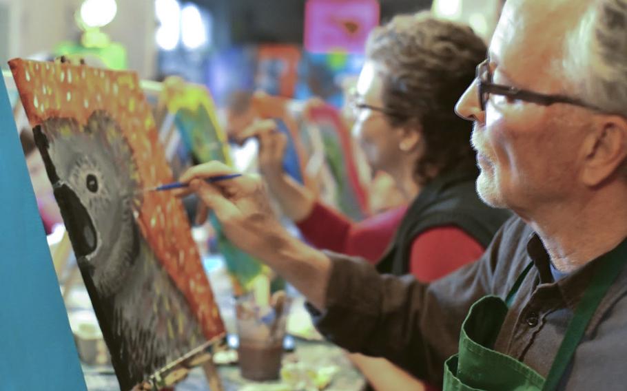 Paul Dutka-Chirichetti paints a koala bear at a charity event for victims of the Australian bushfires in Landstuhl, Germany, on Jan. 25, 2020.