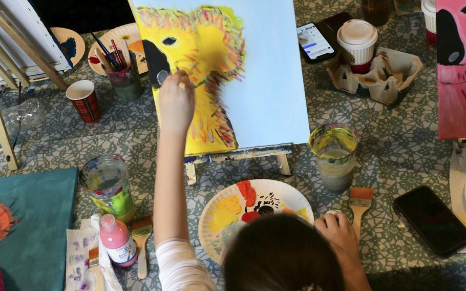 Victoria Young, 10, adds "fur" to the koala bear head she painted at a charity event in Landstuhl, Germany on Jan. 25, 2020. Young and 15 other members of the Kaiserslautern military community raised more than $600 for victims of the Australian bushfires. 