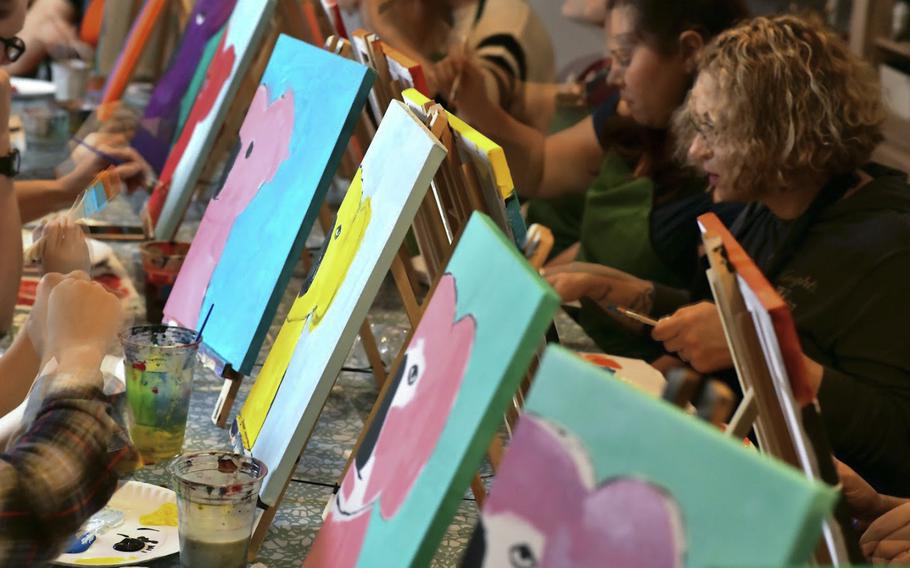 Members of the Kaiserslautern military community paint koala bear heads at a fundraiser in Landstuhl, Germany on Saturday, Jan 25, 2020 for victims of the Australian bushfires.