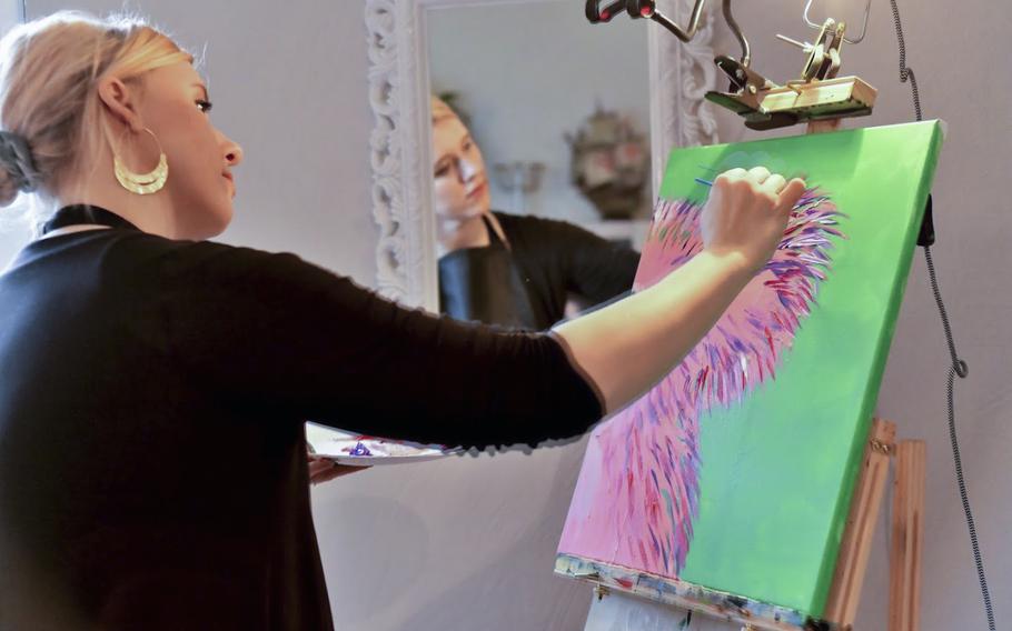 Artist Beatrice Gentry demonstrates to 16 members of the Kaiserslautern military community how to paint a koala, at a fundraiser for victims of the Australian bushfires, in Landstuhl, Germany, on Saturday, Jan. 25, 2020. 