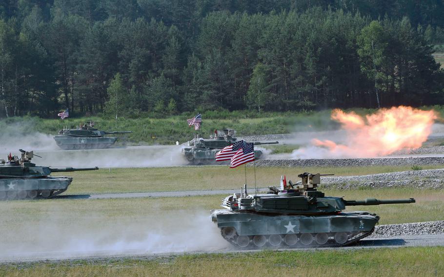 The U.S. tank team fires at targets from its M1A2 Abrams tanks during the Strong Europe Tank Challenge in Grafenwoehr, Germany, in 2018. Heavy ground forces based overseas are the best at deterring conflict, according to a new Rand Corp. study.