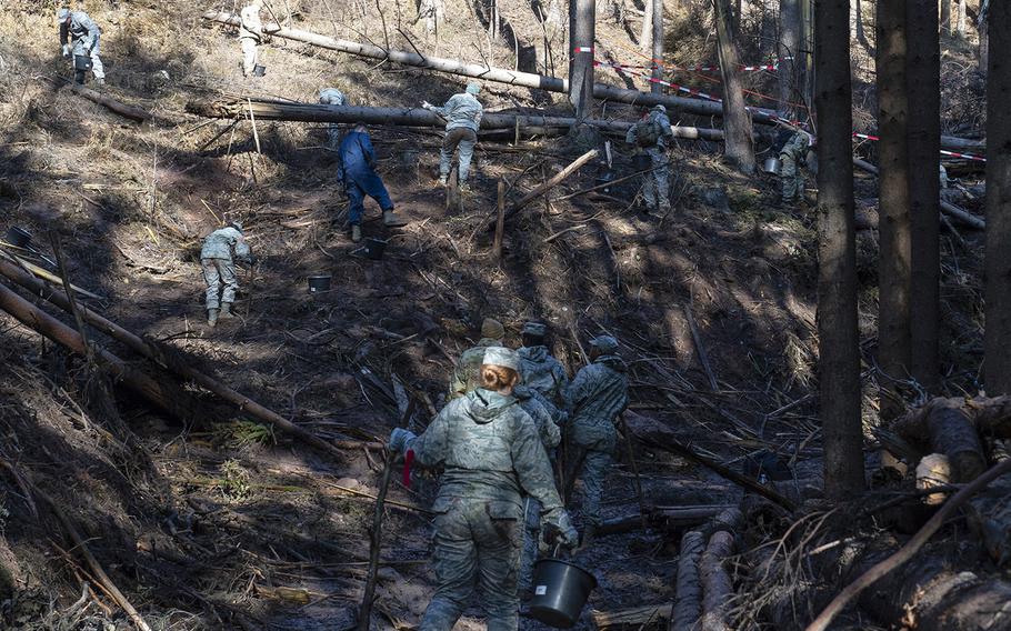 U.S. airmen from the 52nd Fighter Wing scatter across a hillside Oct. 22, 2019, to search and recover wreckage from an F-16 Fighting Falcon that crashed near Zemmer, Germany, Oct. 8, 2019. A partial power failure combined with bad weather caused the jet to crash, the Air Force said Tuesday.