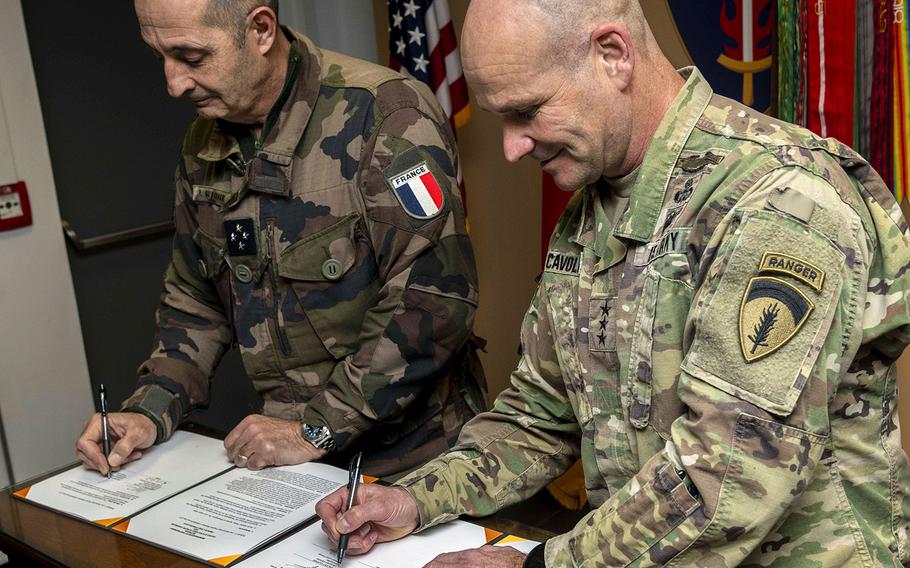 U.S. Army Lt. Gen. Christopher G. Cavoli, right, commanding general of U.S Army Europe, USAREUR, and Lt. Gen. Vincent Guionie, commander of French Land Forces, CFT, sign a memorandum of partnership at Clay Kaserne in Wiesbaden, Germany, Mar. 7, 2020.