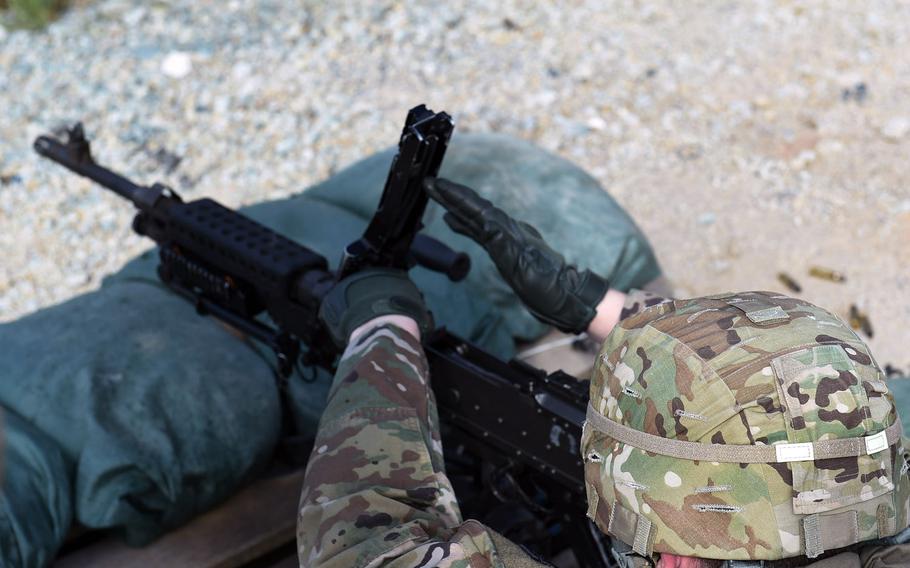 Pfc. Branden Schmidt, an intelligence analyst with the 41st Field Artillery Brigade, prepares to reload an M240B machine gun during an exercise at Grafenwoehr Training Area, April 17, 2020.

