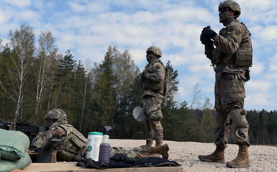 Spc. Nicholas Smith, a fire support specialist with the 41st Field Artillery Brigade, left, fires an M240B machine gun as Sgt. Eamonn Duggan, center, and Spc. Luis Garcia, right, observe during an exercise at Grafenwoehr Training Area, Germany, April 17, 2020.

