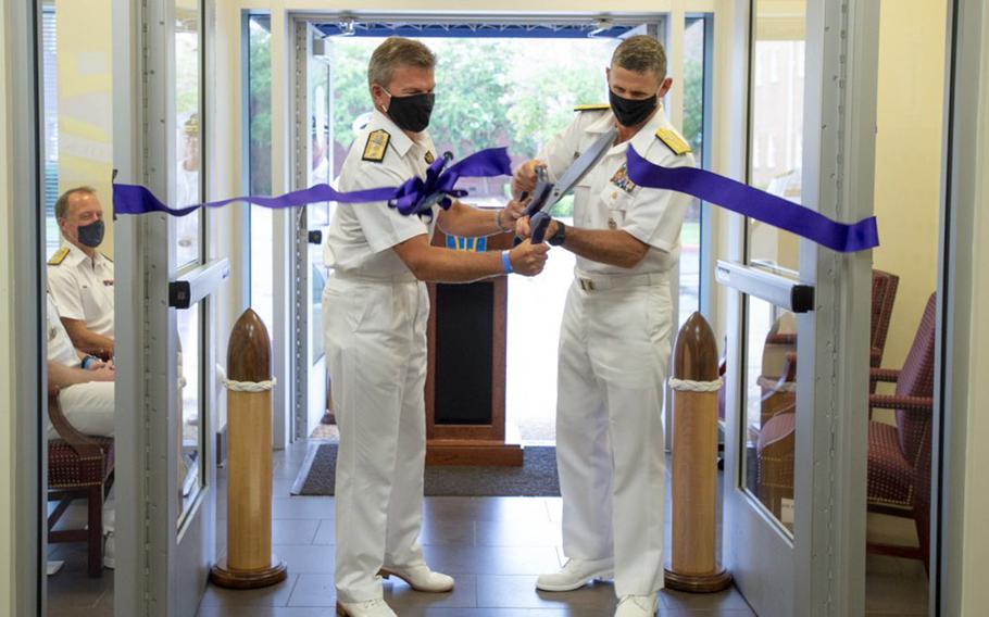 Royal Navy Rear Adm. Andrew Betton, left, and U.S. Vice Adm. Andrew Lewis cut a ribbon at a ceremony at Naval Support Activity, Hampton Roads, Va., Sept. 17, 2020, to mark the start of operations of NATO's new Atlantic Command. 
NATO