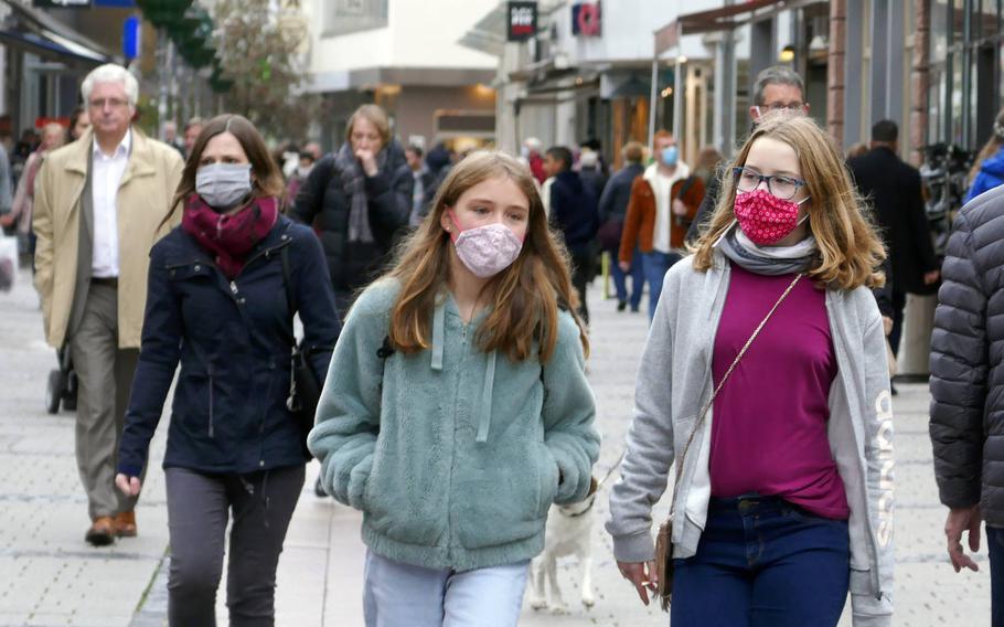 In a Oct. 15, 2020 photo, people walk through downtown Kaiserslautern, Germany. The city was designated a coronavirus high-risk area by German authorities on Saturday.