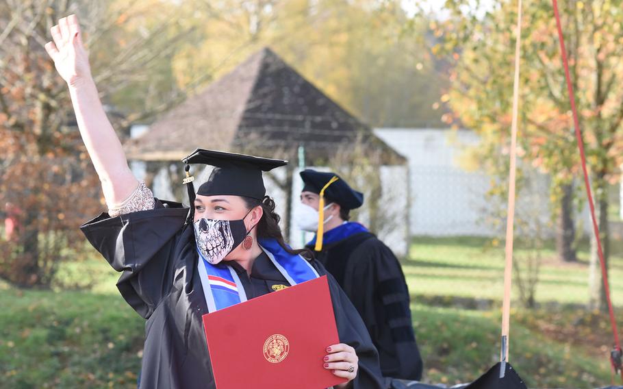 Jessica Clasen waves after receiving her diploma Saturday, Nov 7, 2020, at the University of Maryland Global Campus Europe outdoor commencement ceremony in Kaiserslautern, Germany. A little more than 50 graduates in the class of 2020 walked the stage. The ceremony, originally scheduled for May, had been postponed due to the coronavirus pandemic.