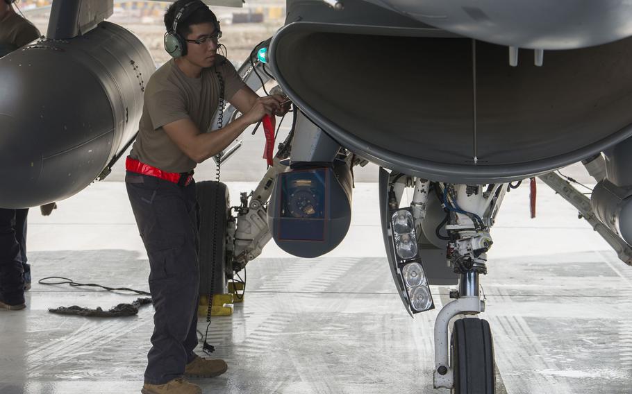 U.S. Air Force Senior Airman Peter Ho, 380th Expeditionary Aircraft Maintenance Squadron, performs post-landing procedures on an F-16 Fighting Falcon at Al Dhafra Air Base, United Arab Emirates, Nov. 12, 2020.