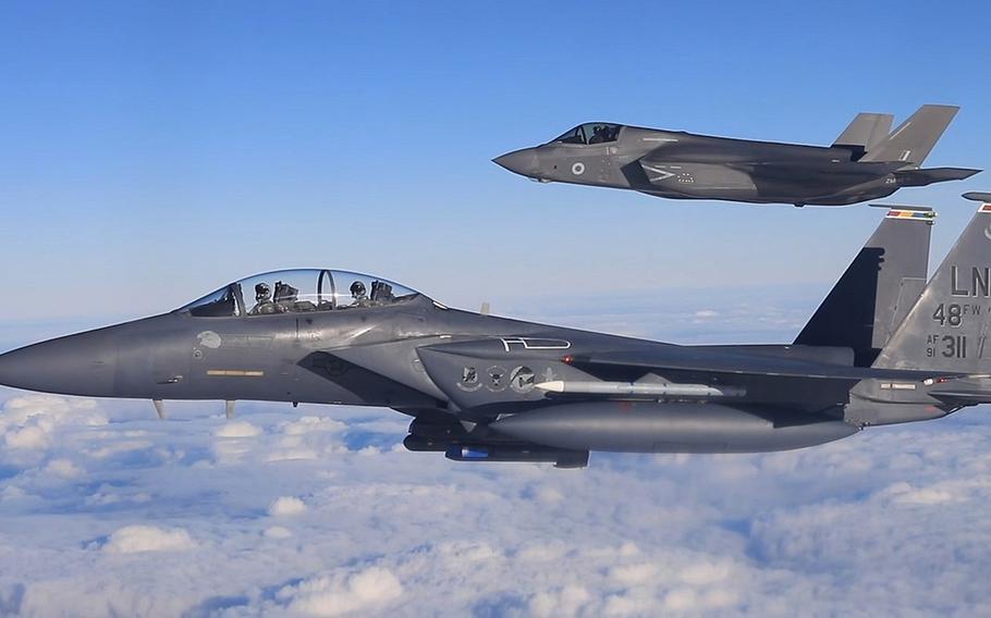 A U.S. Air Force F-15E Strike Eagle from RAF Lakenheath, foreground, and a U.K. F-35B Lightning II from RAF Marham fly in formation in November 2018. Acting Secretary of Defense Christopher C. Miller lauded U.K. plans to give its military the largest spending boost it has seen in 30 years.


