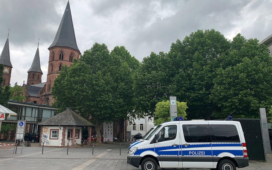 Police vans in a town square.