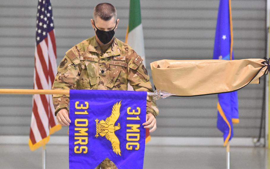 Lt. Col. Clifton Nowell presents the flag of the newly designated 31st Operational Medical Readiness Squadron during a ceremony in October at Aviano Air Base, Italy. The squadron, formerly known as the 31st Aerospace Medical Squadron, will serve the active-duty population on base.