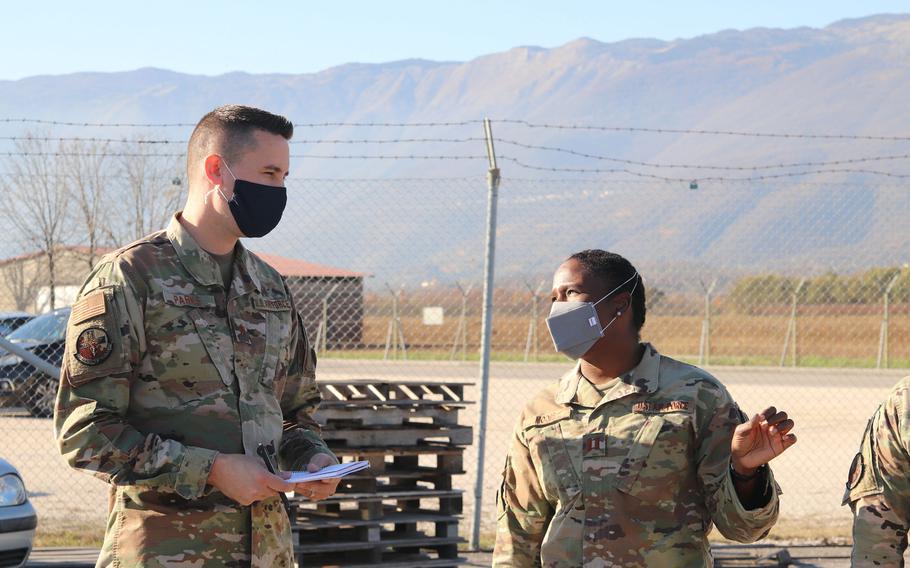Dr.(Maj.) Ryan Parks, left, and Capt. Laquita Moore talk while observing members of the 31st Logistics Readiness Squadron at work on Thursday, Nov. 20, 2020. Parks and Moore, of the 31st Operational Medical Readiness Squadron, are now responsible for the care of individual units instead of the general base population.