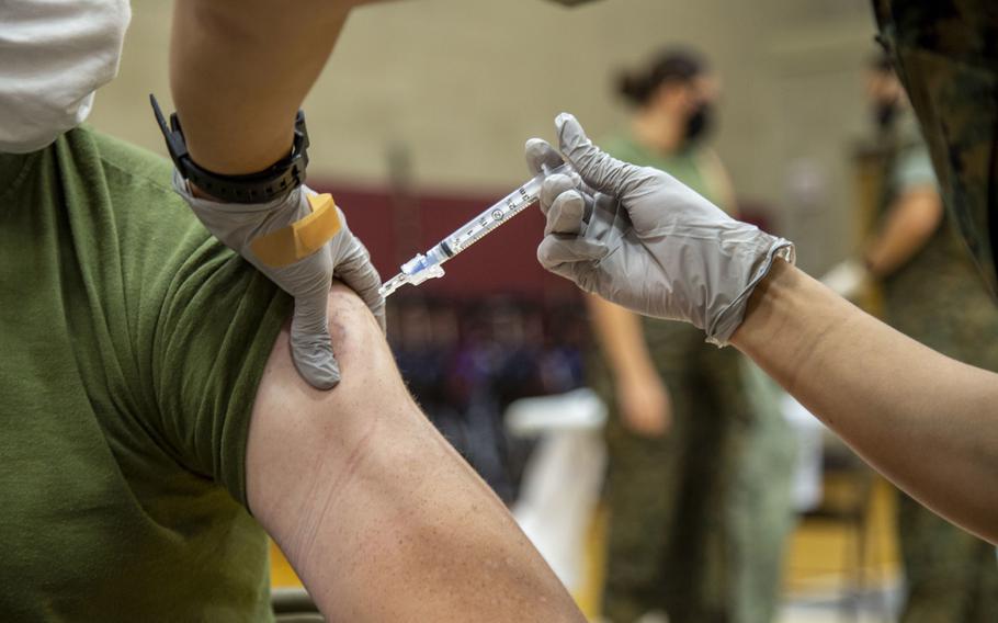 A U.S. Navy corpsman at Marine Corps Air Station New River, N.C., gives a Marine a flu shot, Oct. 22, 2020. Many U.S. military bases in Europe are still waiting to receive their full allotment of the influenza vaccine.

