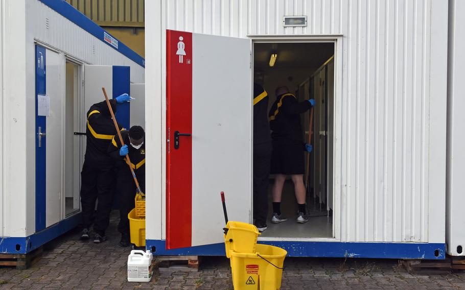 Soldiers at the Task Force Willkommen quarantine facilities on Rhine Ordnance Barracks in Kaiserslautern, Germany, clean their field latrines and showers, Nov. 12, 2020, a daily chore the soldiers perform during their two weeks of restricted movement before moving on to their units.

