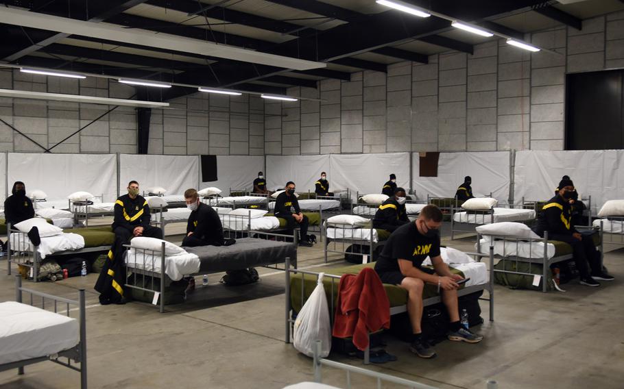 Soldiers rest on their cots inside a warehouse at Rhine Ordnance Barracks, Nov. 12, 2020, part of the Task Force Willkommen mission in Kaiserslautern, Germany, to keep newly arriving soldiers to Germany and Europe from spreading the coronavirus to their units and the local community. The 21st Theater Sustainment Command is currently in charge of the operation.

