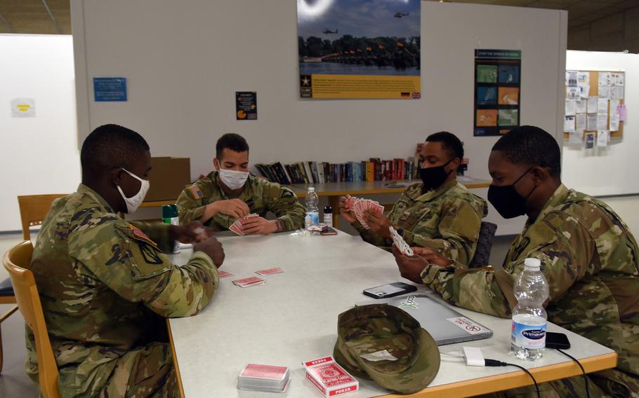 Soldiers play a game of cards Nov. 12, 2020, while under quarantine for 14 days at Rhine Ordnance Barracks in Kaiserslautern, Germany. Unaccompanied, junior enlisted soldiers moving to Germany or transiting through the country on the way to a deployment in Europe quarantine at the facility for two weeks until cleared to go to their units or destination, a process aimed at stopping the spread of the coronavirus.

