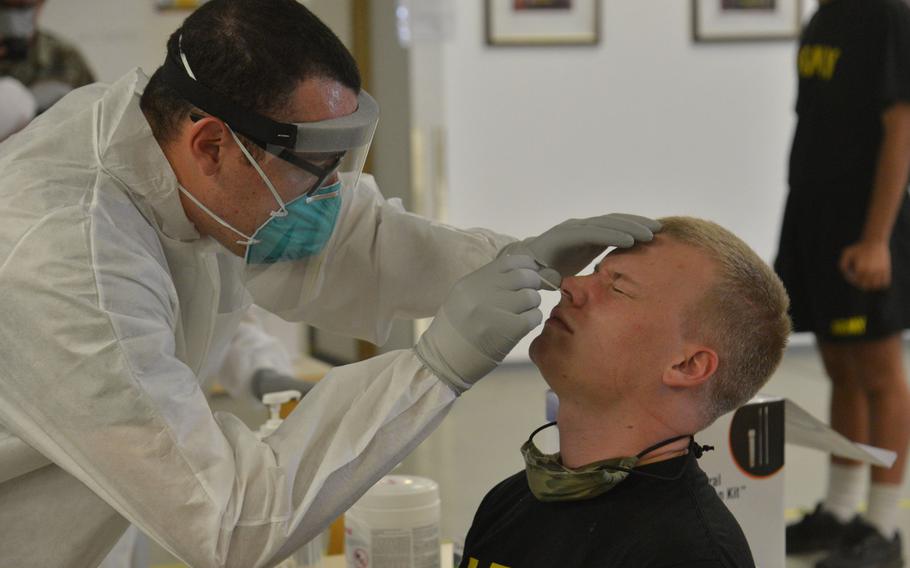 Spc. Elijah Borskey of the 212th Combat Support Hospital gives a soldier on his 10th day in isolation a coronavirus test at the Task Force Willkommen quarantine facilities on Rhine Ordnance Barracks in Kaiserslautern, Germany, in September 2020.










