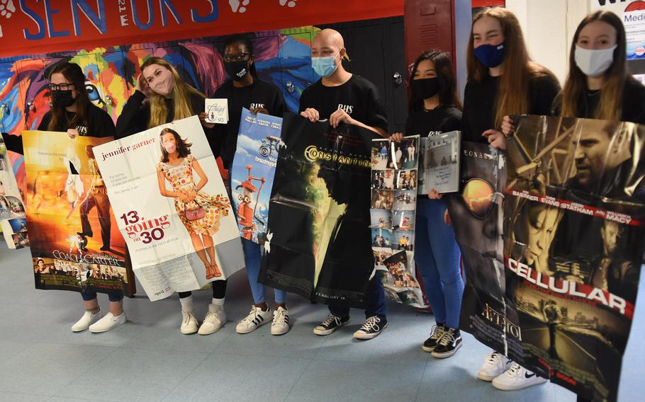 Ramstein High School senior class officers hold up old movie posters left in a time capsule by the class of 2005. The seniors opened the capsule, a padlocked school locker, on Friday, Dec. 11, 2020.
