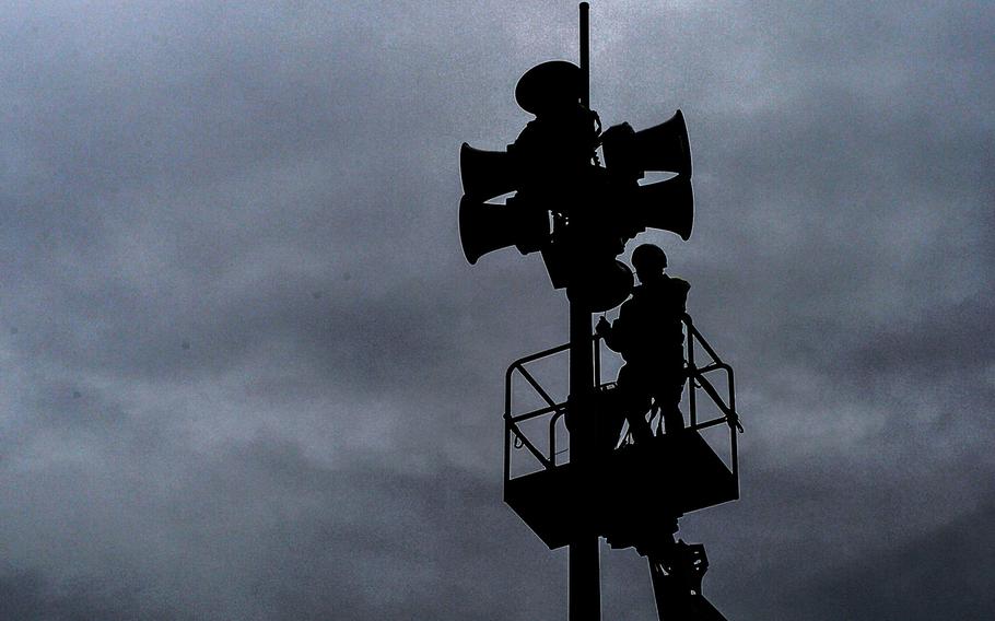 A worker performs maintenance work on a public announcement system on Ramstein Air Base, Germany, in 2017. Sirens sounded on the base's loudspeaker system Dec. 12, 2020, followed by the warning: ''Aerial attack, aerial attack, seek cover, seek cover,'' following a Russian  submarine's test-firing of four intercontinental ballistic missiles.

