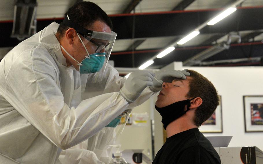 Spc. Elijah Borskey gives a coronavirus test to a soldier at the quarantine facilities in Kaiserslautern, Germany, in September 2020. People should plan in advance for potential exposure to the coronavirus and immediate quarantine or isolation, military medical officials say.