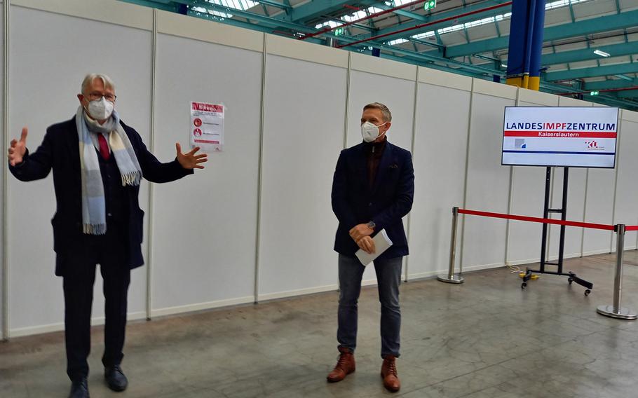 Kaiserslautern Lord Mayor Klaus Weichel, left, and Ralf Lessmeister, Kaiserslautern district commissioner, talk during a Dec. 17, 2020, meeting with reporters at the coronavirus vaccination center in Kaiserslautern, Germany.