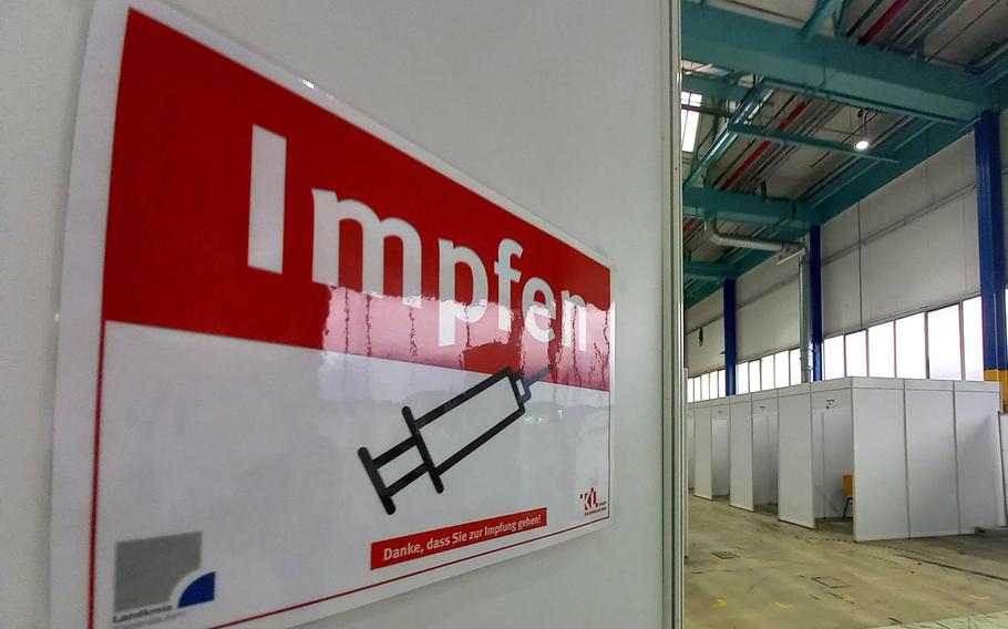 A sign in German reads ''Vaccinate,'' at the vaccination center in Kaiserslautern, Germany, Dec. 17, 2020. In the background are the ''vaccination cabins,'' where people will be inoculated against the coronavirus once the vaccine is approved in Germany.

