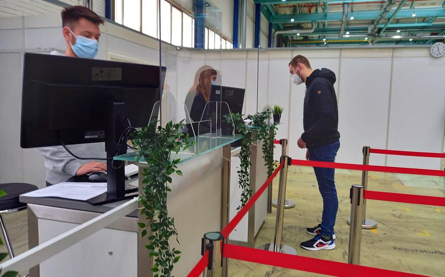 A person proceeds to a checkout desk in a demonstration of procedures at the coronavirus vaccination center in Kaiserslautern, Germany, Dec. 17, 2020.



