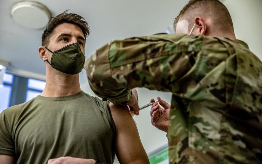 Capt. Skyler Brown, a family medicine physician assigned to the 173rd Airborne Brigade Combat Team, receives the Moderna COVID-19 vaccine from Pfc. Luca Webe at the U.S. Army Health Clinic in Grafenwoehr, Germany, on Dec. 28, 2020. Brown was the first servicemember in all of U.S. Army Europe and Africa to receive the vaccine, an Army official said.   

