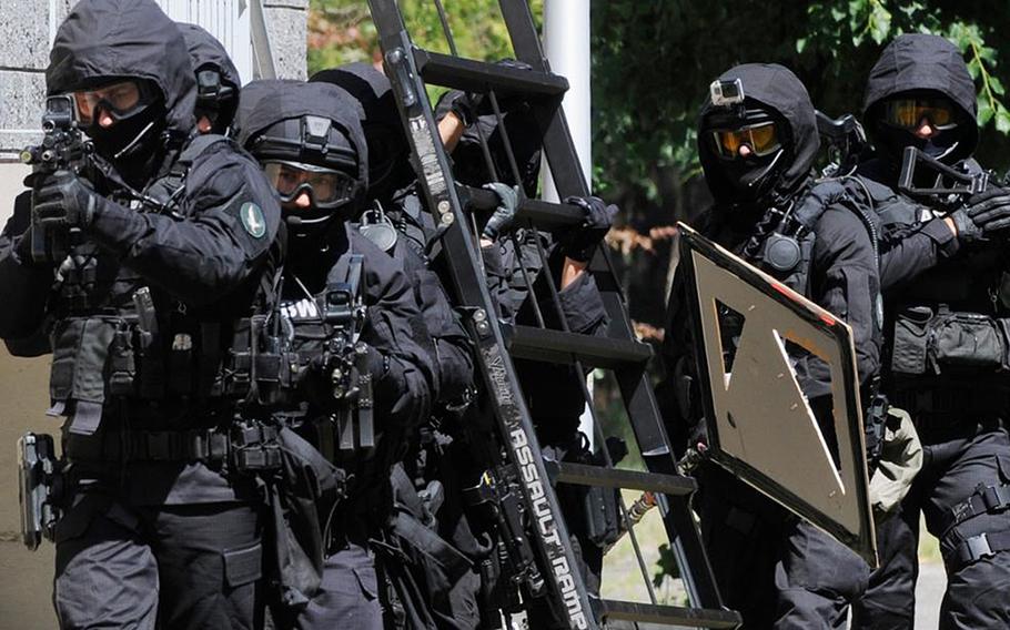 Two Iraqis who were detained in June by Poland's counter-terrorism and counter-intelligence service, the Internal Security Agency, or ABW, were charged with helping to fund the Islamic State terrorist group in a court in Wroclaw, in western Poland, Dec. 14, 2020.