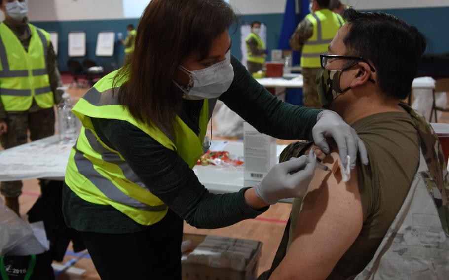 Sarah Lewis, a registered nurse with the 86th Medical Group, vaccinates Col. Ryan Mihata, the 86th Medical Group commander, at Ramstein Air Base, Germany, on Monday, Jan. 4, 2021, against the disease caused by the coronavirus.
