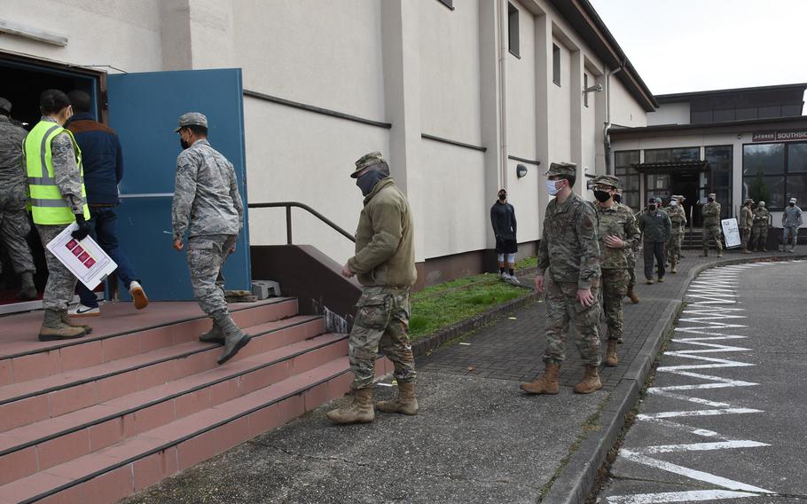 Socially distanced airmen enter the Southside Fitness Center Annex at Ramstein Air Base, Germany, on Dec. 8, 2020, to get their flu shots. Service members were prioritized for the flu vaccine when it became available in limited doses in the fall. 
